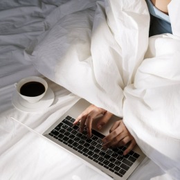 a woman typing on a laptop