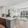 living room with large kitchen and living room with floor to ceiling windows