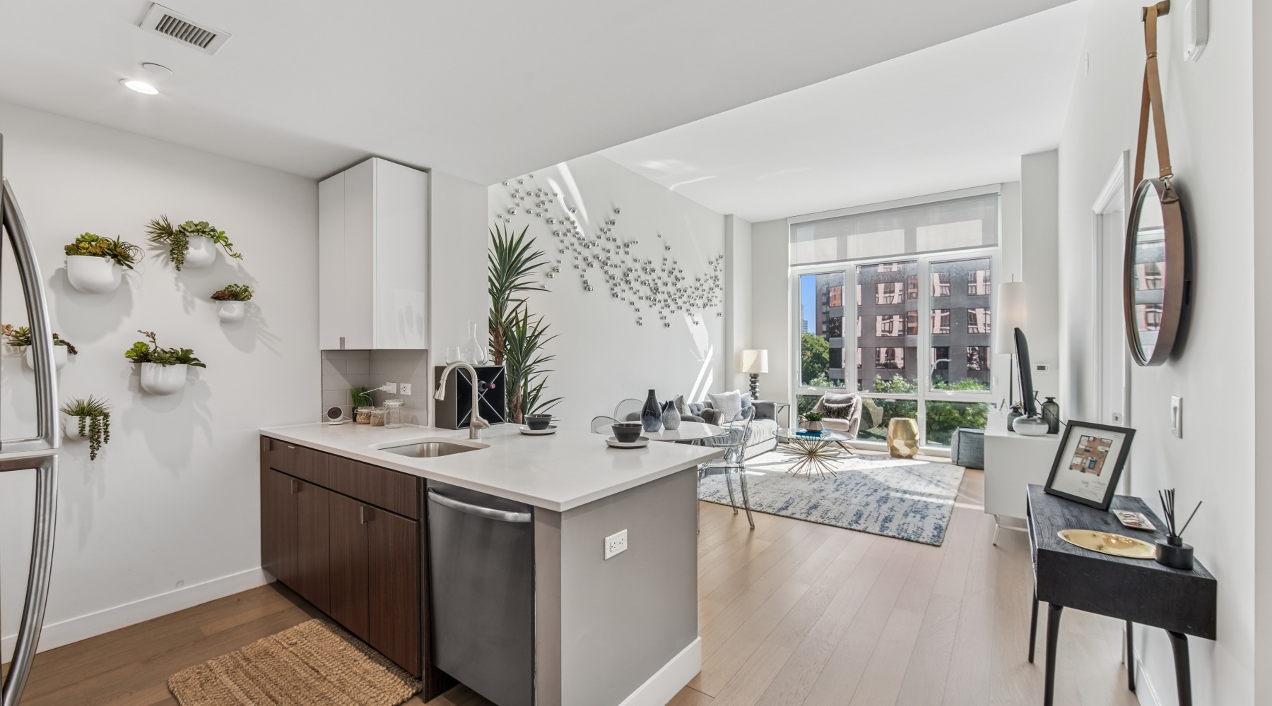 living room with large kitchen and living room with floor to ceiling windows