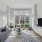 living room with large windows and a couch and tv
