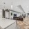 community kitchen area with bar stool seating and couches in the background
