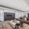 seating area with tvs and couches and large windows