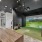 a room with a table and chairs and a golf simulator