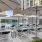 lounge chairs and umbrellas next to a swimming pool in a courtyard